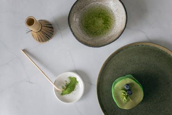 Matcha Kit including matcha powder diluted with water in a bowl.